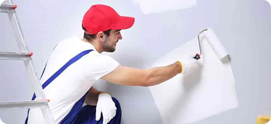 Painter decorating a wall