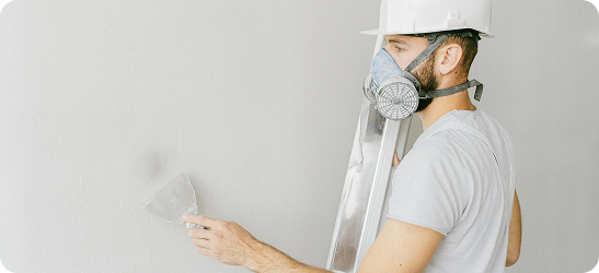 Plasterer with protective mask